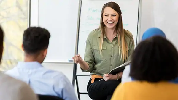 Smiling teacher leading a class –Study Swedish in Malmö at Folkuniversitetet 